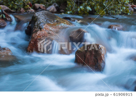 Nature scene of rough, fast flowing river hitting 61906915
