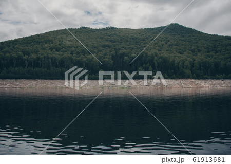 the concept of boating, recreation, travel - splashes of blue water in the river, mountains, sky. Copy space 61913681