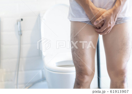 Closeup man holding bladder with pee pain 61913907