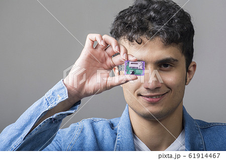 Young man holding a USB connectivity for standard Young man holding a USB connectivity for standard 61914467