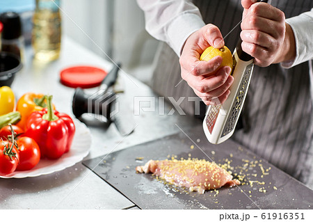 Chief chops and marinates chicken. Professional chef in a kitchen of restaurant cooking. Chief chops and marinates chicken. Professional chef in a kitchen of restaurant cooking. 61916351