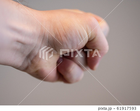 A man's fist punching into copy space A man's fist punching into copy space 61917593