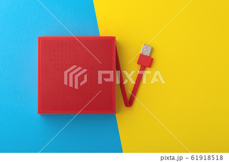 Red portable speaker on blue and yellow background Red portable speaker on blue and yellow background 61918518