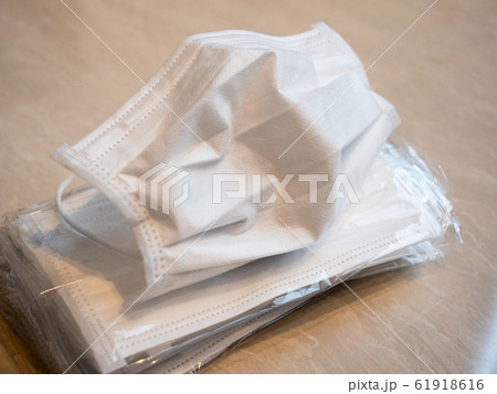 A pile of white surgical masks for flu season A pile of white surgical masks for flu season 61918616