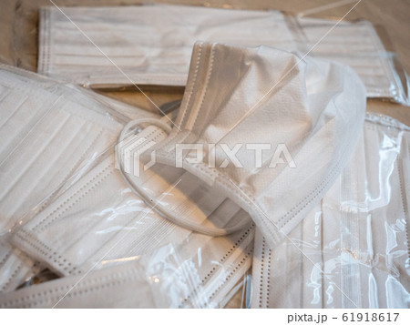 A pile of white surgical masks used to prevent the spread of viruses 61918617