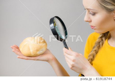 Bun bread roll and magnifying glass 61918744