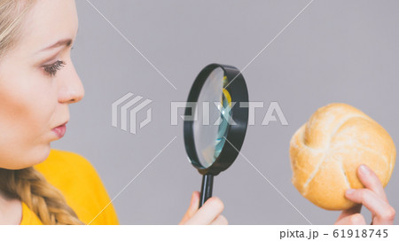 Bun bread roll and magnifying glass 61918745