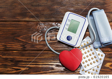 White electric tonometer, red heart and pills, on White electric tonometer, red heart and pills, on 61920165