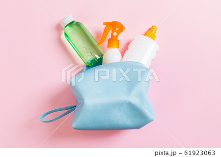 Top view of female cosmetics bag full of suncream 61923063