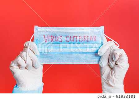 Female hands in medical gloves holding protective 61923181