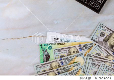 1040 Tax form with refund check and currency US 61923223