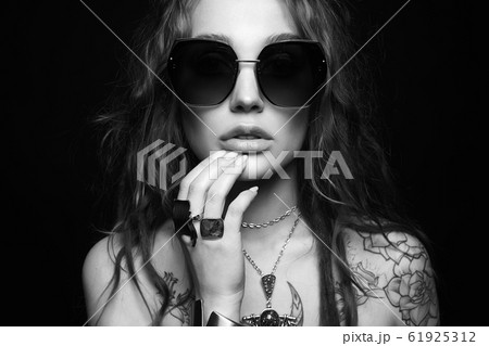 tattooed girl in sunglasses and jewelry tattooed girl in sunglasses and jewelry 61925312