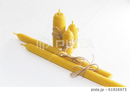 a group of wax candles tied with a rope. Natural 61926973