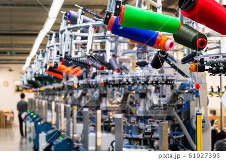 Colorful reel thread set up at modern and automatic sewing or embroidery spinning machine, textile industry factory concept Colorful reel thread set up at modern and automatic sewing or embroidery spinning machine, textile industry factory concept 61927395