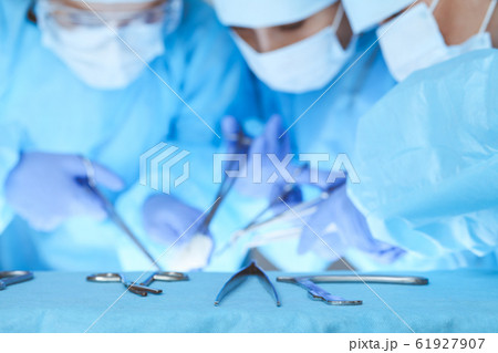 Close-up of medical team performing operation. Group of surgeons at work are busy of patient. Medicine, veterinary or healthcare and emergency in hospital Close-up of medical team performing operation. Group of surgeons at work are busy of patient. Medicine, veterinary or healthcare and emergency in hospital 61927907