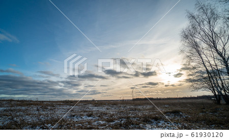 Beautiful setting sun over frozen field Beautiful setting sun over frozen field 61930120