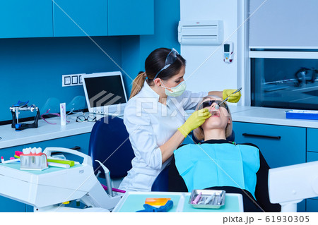 Portrait of a female dentist and young woman in a dentist office Portrait of a female dentist and young woman in a dentist office 61930305