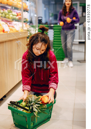 Cute little girl in a supermarket Cute little girl in a supermarket 61930778
