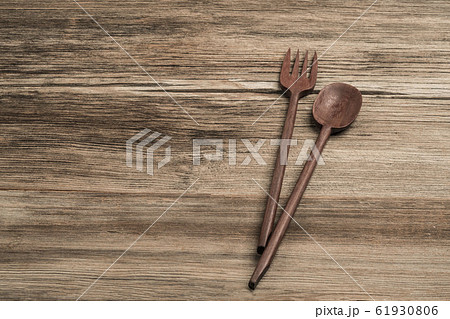 carved spoon and fork on a wooden table carved spoon and fork on a wooden table 61930806