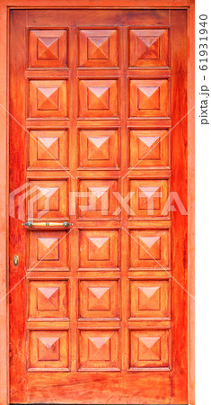 Old orange wooden entrance doors with a bronze 61931940