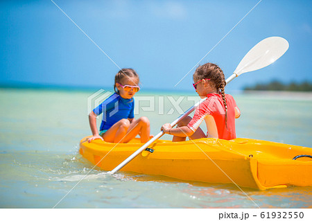 Little adorable girls enjoying kayaking on yellow kayak 61932550
