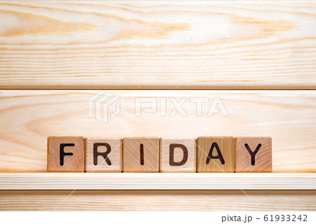 Day of the week. Friday made from vintage wooden cubes. Last working day. Calendar background. Week 61933242