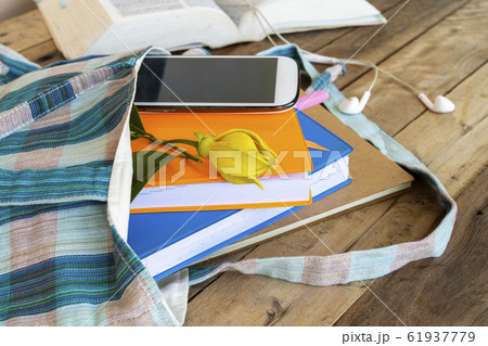 notebook ,diary and mobile phone in cloth bag with dictionary book for study of student 61937779