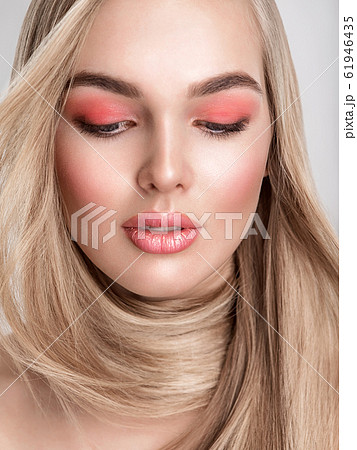 Portrait of a beautiful woman with a coral color Portrait of a beautiful woman with a coral color 61946435