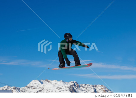 Snowboarder against the blue sky in Livigno, Italy Snowboarder against the blue sky in Livigno, Italy 61947391