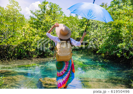 A young traveler girl relax in the holiday enjoying the beauty of nature lake A young traveler girl relax in the holiday enjoying the beauty of nature lake 61950496