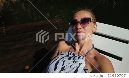 Woman shooting self portrait. Take photo and video on smartphone. Girl rest, relax, walk in sunglasses, make selfie. Blogger broadcast video vlogging. 61950707