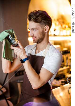 Gentle Caucasian waiter posing for camera indoors 61954496