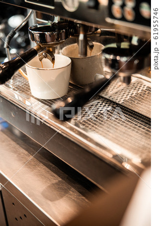 Cropped photo of espresso machine pouring coffee into the mug 61955746