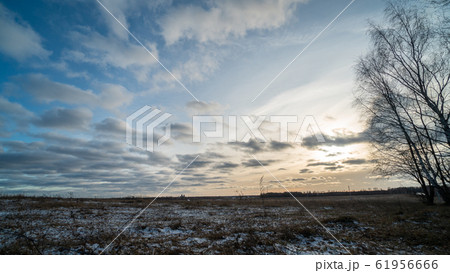 Beautiful setting sun over frozen field 61956666