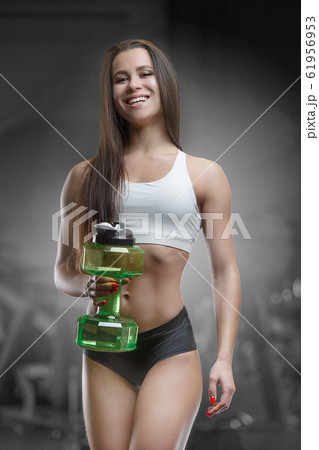 Fitness woman drinking water at workout in the gym Fitness woman drinking water at workout in the gym 61956953