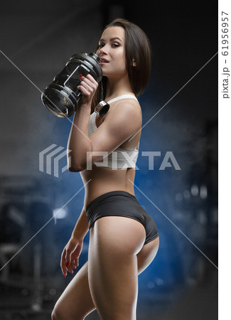 Gym Fitness Woman Earphones Drinking Water Bottle Cardio Workout While  Stock Photo by ©PeopleImages.com 620654246