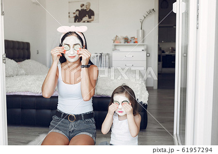 Mother and daughter doing spa treatments for the face at home Mother and daughter doing spa treatments for the face at home 61957294