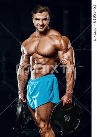 good looking fitness man pumping up muscles good looking fitness man pumping up muscles 61959452