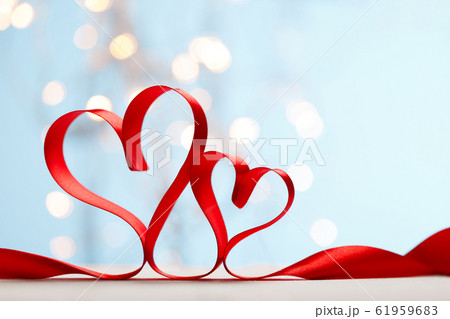 Ribbon shaped as hearts on blue background with lights Ribbon shaped as hearts on blue background with lights 61959683