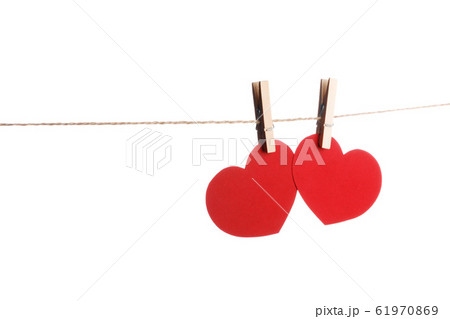 Clothes pegs and two red paper hearts 61970869
