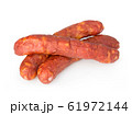 Stack of cooked sausages close-up isolated. 61972144