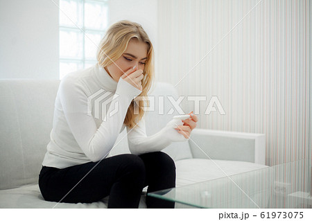 Worried sad woman Looking at a Pregnancy Test after result. Worried sad woman Looking at a Pregnancy Test after result. 61973075