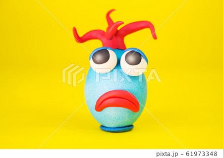 Easter Egg Cartoonish Character With Plasticine Eyes, Mouth and Hair Having an Expressive Face Easter Egg Cartoonish Character With Plasticine Eyes, Mouth and Hair Having an Expressive Face 61973348