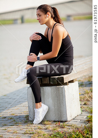 Woman Suffering From Pain In Leg After Workout 61973585