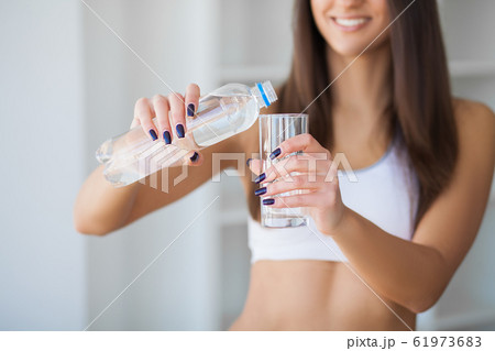 Portrait Of Happy Smiling Young Woman With Bottle Of Fresh Water Portrait Of Happy Smiling Young Woman With Bottle Of Fresh Water 61973683
