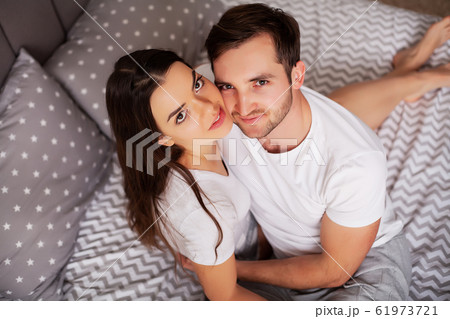 Intimate sensual young couple in bedroom enjoying each other 61973721