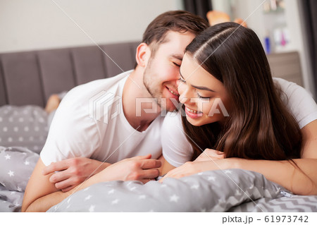 Intimate sensual young couple in bedroom enjoying each other Intimate sensual young couple in bedroom enjoying each other 61973742