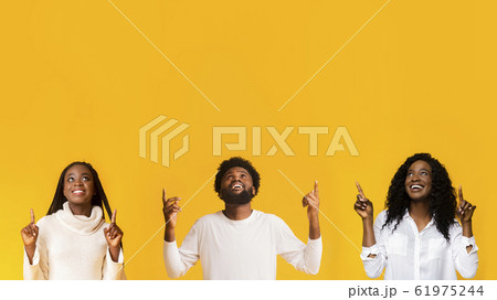 Happy black guy and two girls looking up 61975244