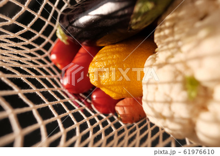 Closeup vegetables and fruits in a rope bag  61976610