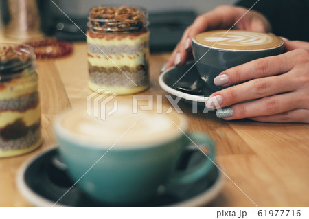 Close up of female hands holding coffee mug 61977716